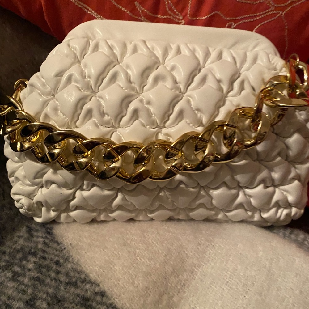 White faux leather clutch.